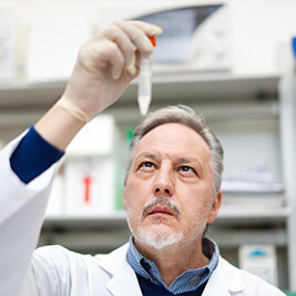 male physician checking a test tube