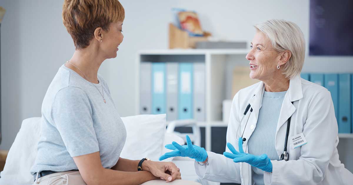 Mature woman talking with mature female doctor