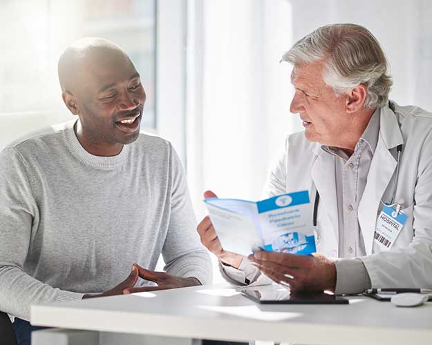 Bald man speaking with doctor