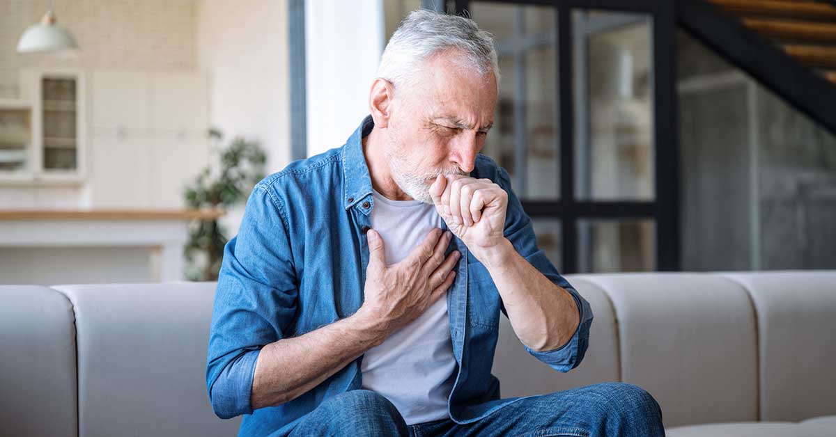 Man having asthma attack, difficulties with breathe, feeling severe pain.