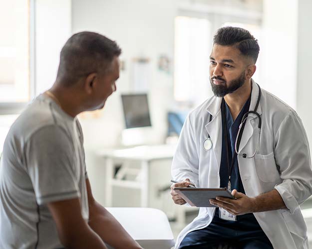 Man Talking to Male Doctor
