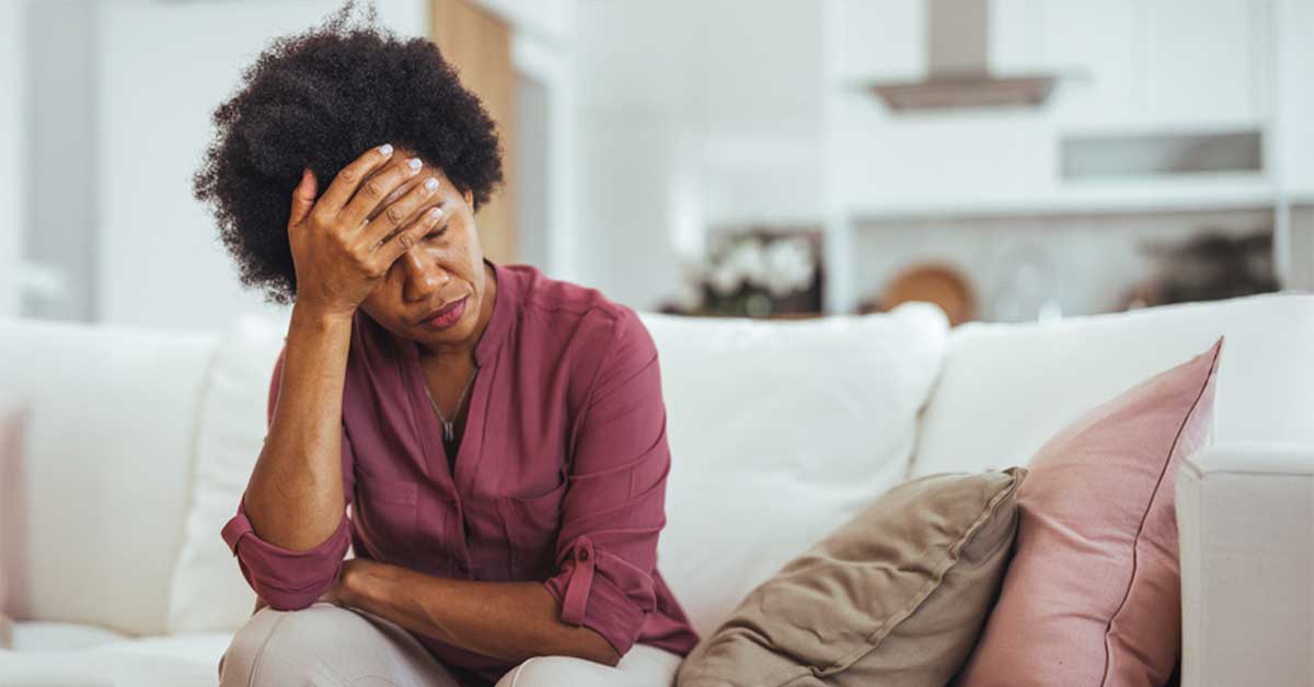 Woman Sitting On Sofa Tired