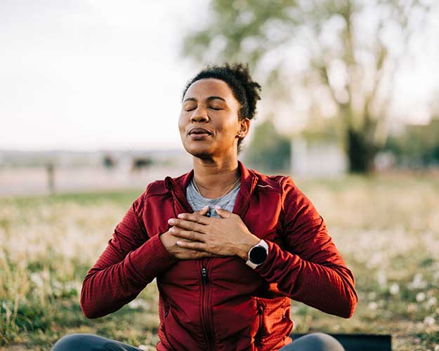 woman meditating outside