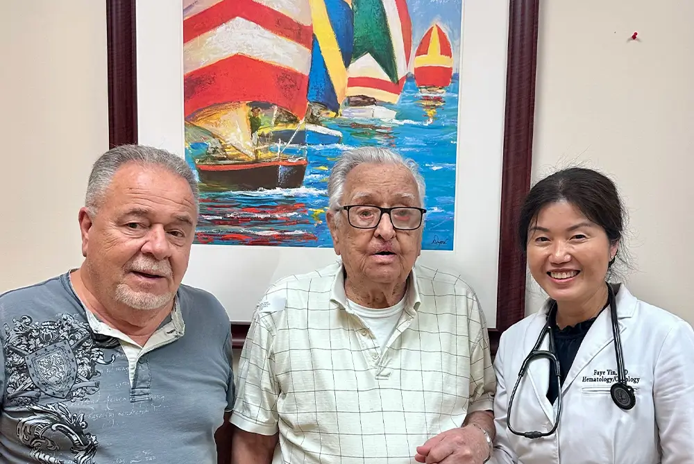 Basal cell carcinoma patient Joseph K., 99, with family and hematologist-oncologist Dr. Faye Yin celebrating successful targeted therapy treatment