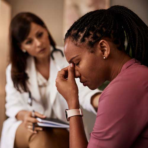 depressed woman with doctor.