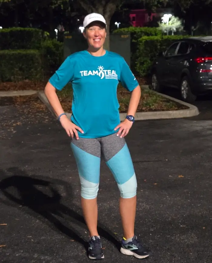 Ovarian cancer survivor Hollie Nelsen training at night in her Team Teal shirt in preparation for the 2026 Boston Marathon