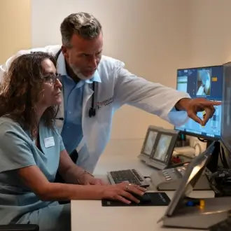 Board-certified FCS oncologist consulting with a cancer patient about their treatment plan