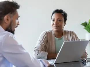 FCS financial counselor reviewing cancer treatment costs and coverage options with a patient