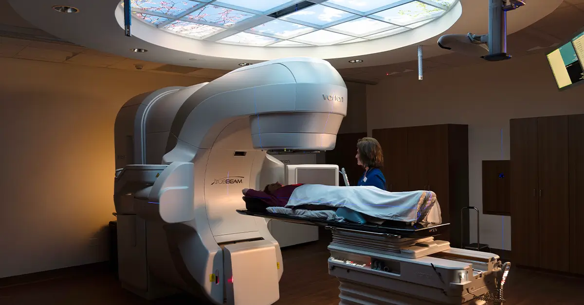 A cancer patient receiving advanced radiation therapy in a modern treatment room